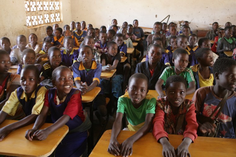 Kids in Malawi sitting at the new desks provided by the K.I.N.D. fund.