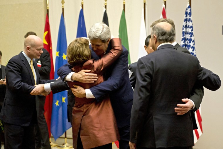 U.S. Secretary of State John Kerry, center, embraces EU foreign policy chief Catherine Ashton, during a ceremony at the United Nations after an agreement was reached on Iran's nuclear program,  in Geneva, Switzerland, Sunday, Nov. 24, 2013.