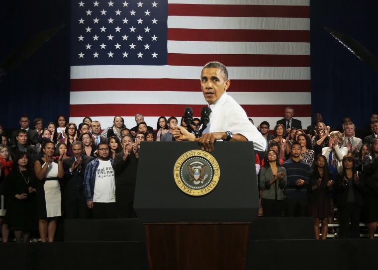 President Barack Obama turns around to respond to hecklers interrupting his speech about immigration reform, Nov. 25, 2013.
