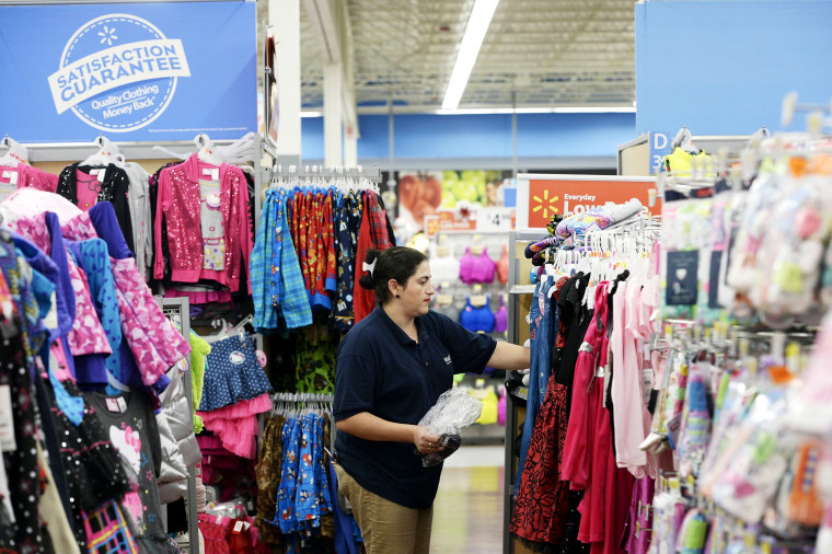 A worker stocks merchandise at the Wal-Mart Superstore in the Porter Ranch section of Los Angeles November 26, 2013.