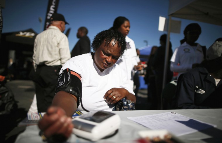Bernita Jackson, 51, has her blood pressure measured at an event to inform people about the Affordable Care Act and donate turkeys to 5,000 needy families, in Los Angeles, Calif on Nov. 25, 2013.