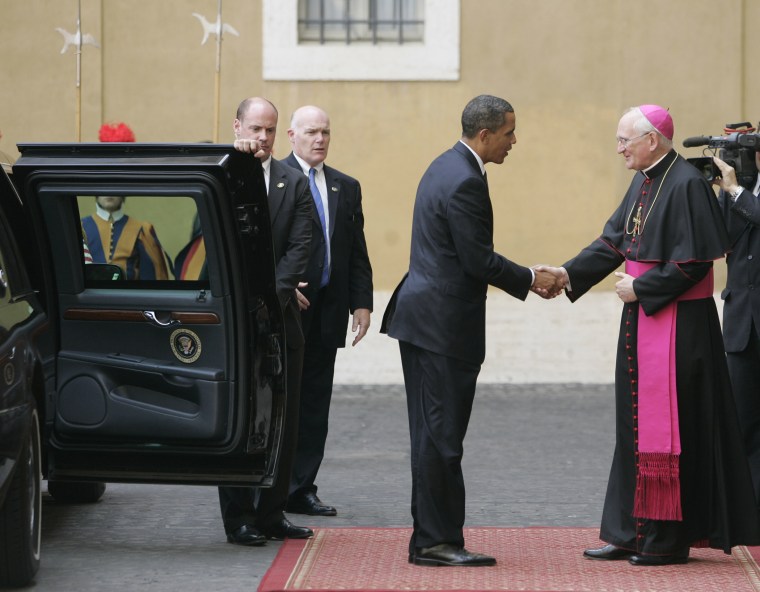 President Barack Obama is welcomed by Bishop James Harvey, at right, as he arrives at the Vatican for a meeting with Pope Benedict XVI, Friday July 10, 2009.
