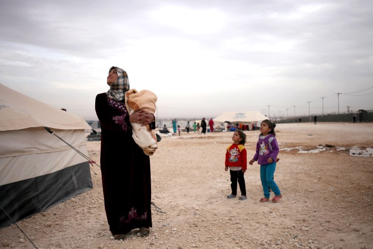 A Syrian mother and her daughters in Zaatari refugee camp, near the Syrian border, in Mafraq, Jordan, on Dec. 3, 2013.
