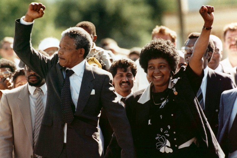 Nelson Mandela and his wife, Winnie, raise clenched fists as they walk hand-in-hand upon his release from prison in Cape Town, South Africa on Feb. 11, 1990.