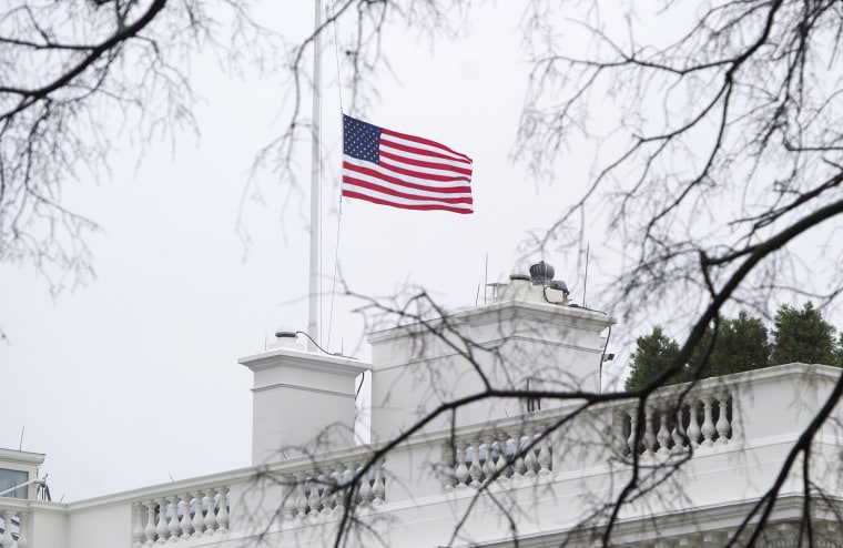 The US flag flies at half staff over the White House in honor of former South African President Nelson Mandela in Washington, DC, on December 6, 2013.