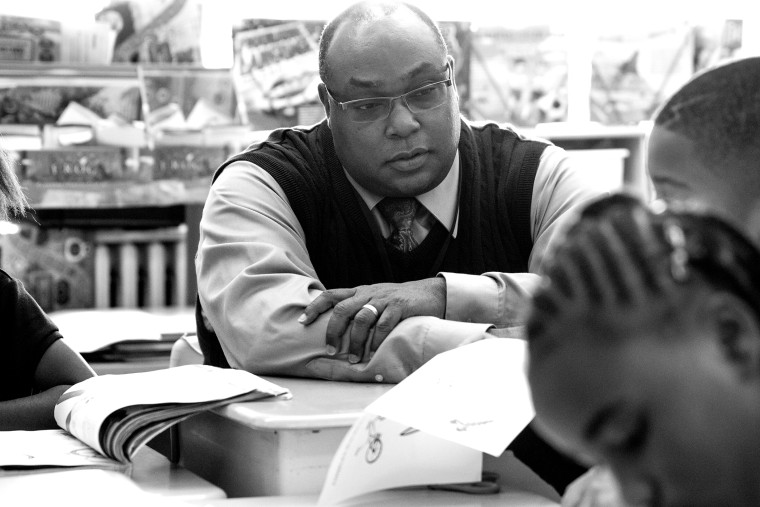 Dr. Tyrone McNichols the superintendent of the beleaguered Normandy School District, sits with students at Washington Elementary in St. Louis, Mo.