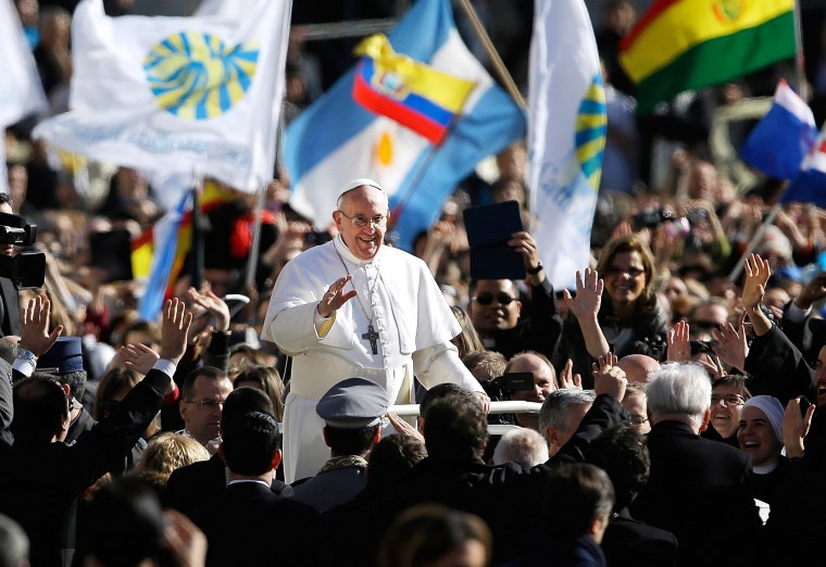 Pope Francis waves to crowds as he arrives to his inauguration Mass in St. Peter's Square at the Vatican, March 19, 2013.