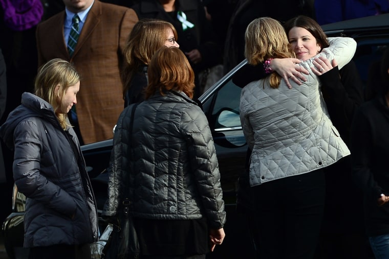 Krista (R) Rekos, the mother of Jessica Rekos, 6, is comforted after a funeral service at Saint Rose of Lima Church on Dec. 18, 2012 in Newtown, Conn.