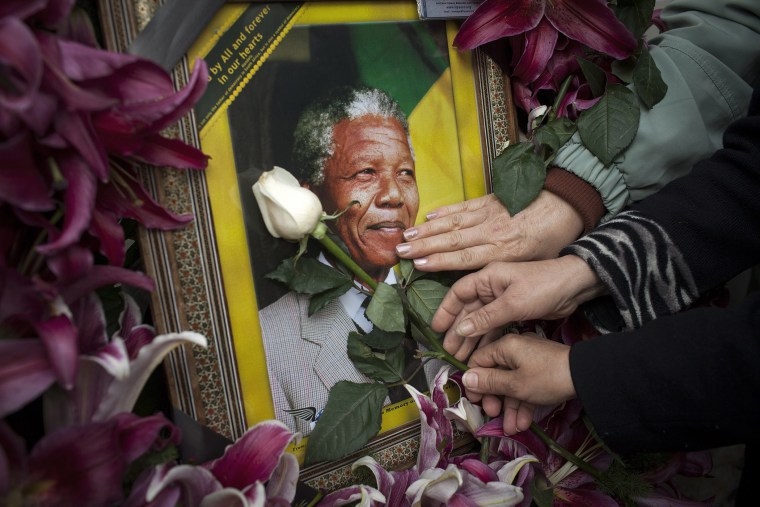 Mourners gathered in front of the South African embassy to pay their respects to the memory of Nelson Mandela on December 7, 2013 in Tehran, Iran.