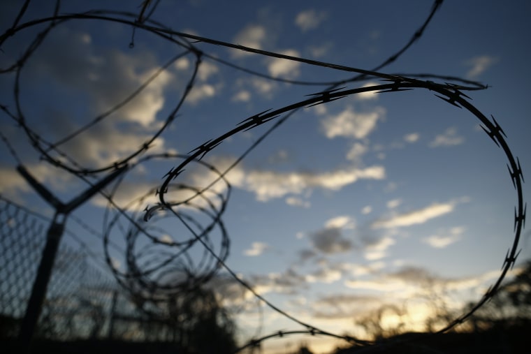 In this photo reviewed by the U.S. military, concertina wire hangs off a fence in the now abandoned Camp X-Ray, which was used as the first detention facility for al-Qaida and Taliban militants who were captured after the Sept. 11 attacks at Guantanamo Ba