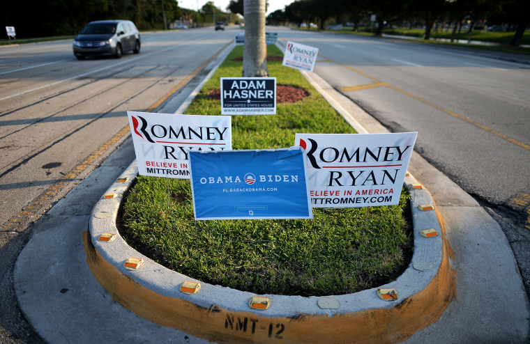 Competing signs for US President Barack Obama and his Republican rival Mitt Romney are seen in Boca Raton, Fl., on Oct. 20, 2012.