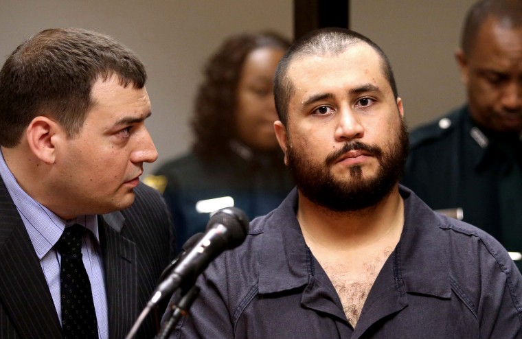 George Zimmerman, the acquitted shooter in the death of Trayvon Martin, listens to defense counsel Daniel Megaro (L) during a first-appearance hearing on charges including aggravated assault stemming from a fight with his girlfriend Nov. 19, 2013 in Sanfo