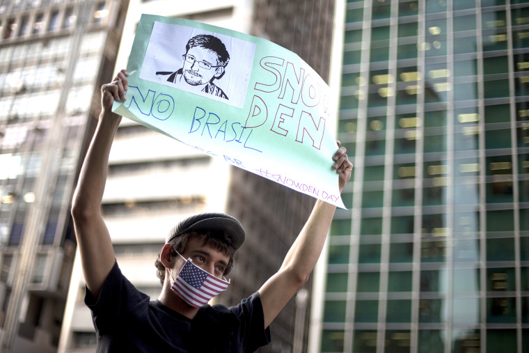 A demonstrator holds up a poster with a drawing depicting National Security Agency leaker Edward Snowden with a message that reads in Portuguese; \"Snowden in Brazil,\" during a protest in Sao Paulo, Brazil, on July 18, 2013.&nbsp;
