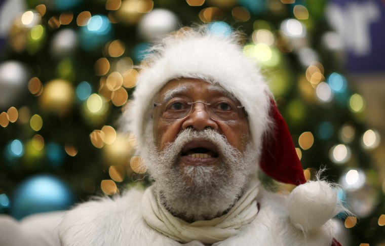 African American Santa Claus Langston Patterson, 77, waits for children to arrive at Baldwin Hills Crenshaw Plaza mall in Los Angeles, Dec. 16, 2013.
