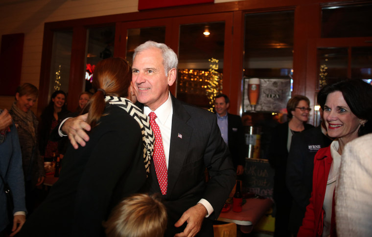 Republican Bradley Byrne and his wife, Rebecca, right, celebrate with supporters after arriving to Byrne's election night headquarters at Moe's Original BBQ in downtown Mobile, Ala., on Tuesday, Dec. 17, 2013.