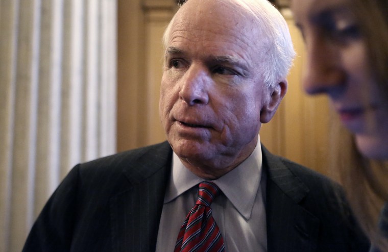 U.S. Senator McCain talks to reporters after a Senate cloture vote on budget bill on Capitol Hill in Washington