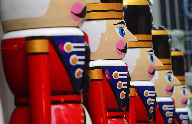 Giant nutcracker statues are set as holiday decorations in front of an office building in New York, Dec. 17, 2013