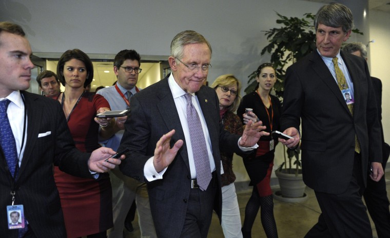 Senate Majority Leader Harry Reid of Nevada is pursued by reporters on Capitol Hill in Washington, Wednesday, Dec. 11, 2013, following a closed-door briefing on the recent agreement reached between Iran and western powers on Iran's nuclear program.