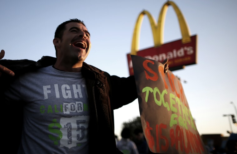 Striking McDonald's worker Abran Escarzaga, 31, protests outside McDonald's in Los Angeles