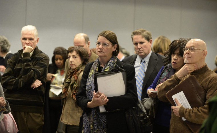 Potential job seekers speak with employers at a job fair in New York, New York, November 20, 2013..