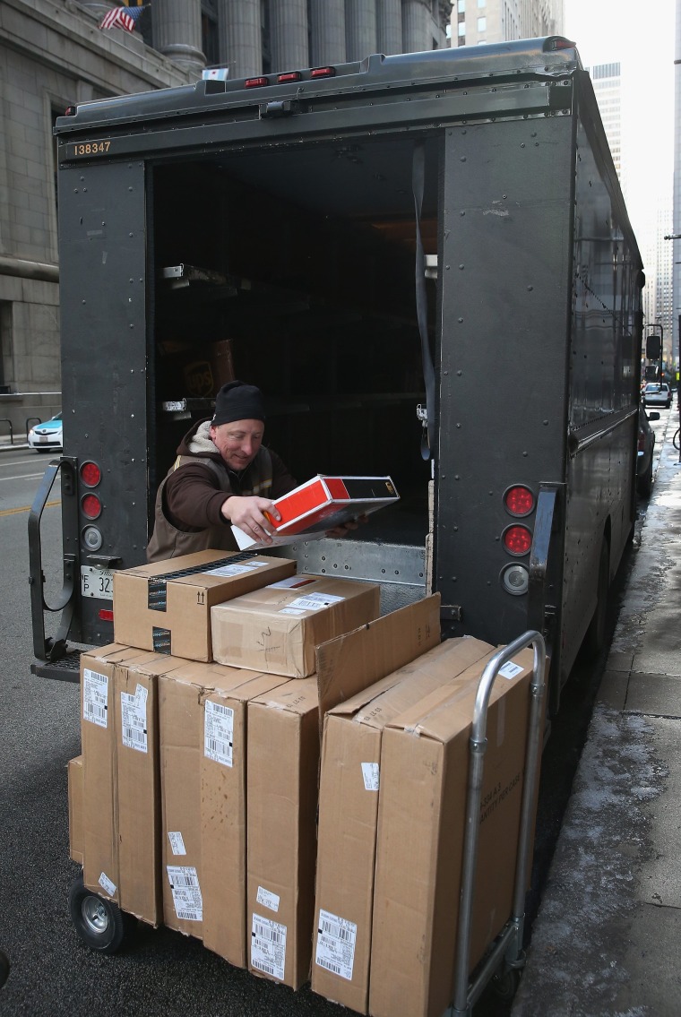 A UPS worker delivers packages on December 26, 2013 in Chicago, Illinois.