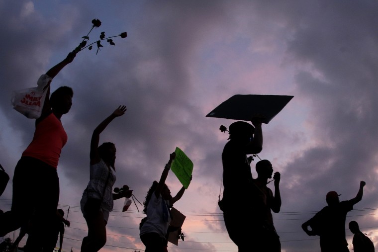 People protest for Michael Brown, who was killed by a police officer Aug. 9 in Ferguson, Mo on Aug. 18, 2014. (Photo by Charlie Riedel/AP)