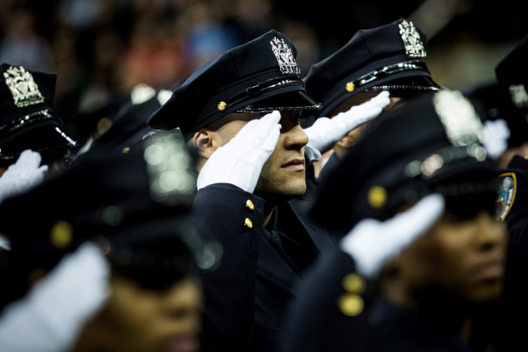 Police officers attend their New York Police Department graduation ceremony at Madison Square Garden on Dec. 29, 2014 in New York City.