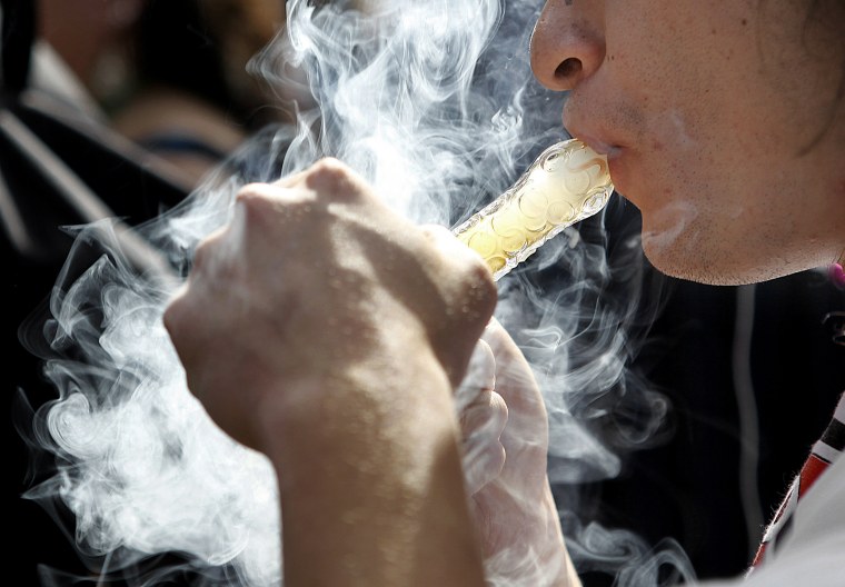 A man smokes as thousands gathered to celebrate the state's nedicinal marijuana laws and collectively light up at 4:20 p.m. in Civic Center Park April 20, 2012 in Denver, Colo.