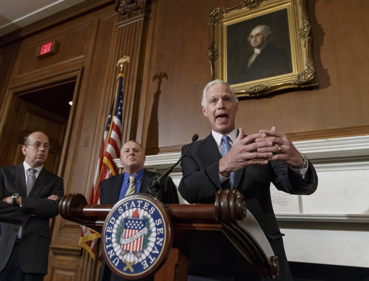 Sen. Ron Johnson, R-Wis., joined by attorneys Paul D. Clement, far left, and Rick Esenberg, second from left, announces that he has filed a lawsuit to block the federal government from helping to pay for health care coverage for members of Congress and th