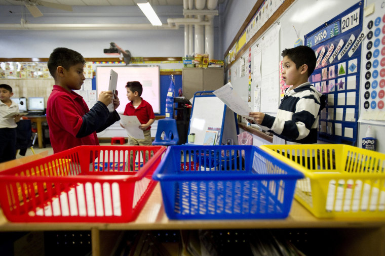 Josue Rodgriquez, 7, (left) records fellow second grader Santiago Gorostieta, 8, as he reads a Spanish-language poster he created at Treadwell Elementary School in Memphis, Tenn., Friday, January 10, 2014.