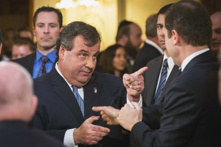 New Jersey Governor Chris Christie greets a member of the assembly as he arrives for his annual State of the State address in Trenton, New Jersey January 14, 2014.