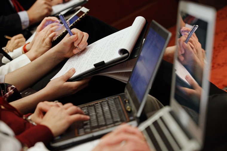 Reporters take notes during a panel discussion at the U.S. Capitol, Jan. 19, 2012.