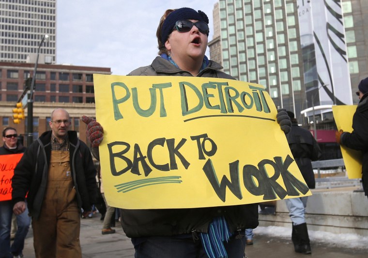 Jennifer Teed joins a group of labor activists as they rally for jobs outside Cobo Center ahead of the media preview of the North American International Auto Show in Detroit, Michigan January 12, 2014.