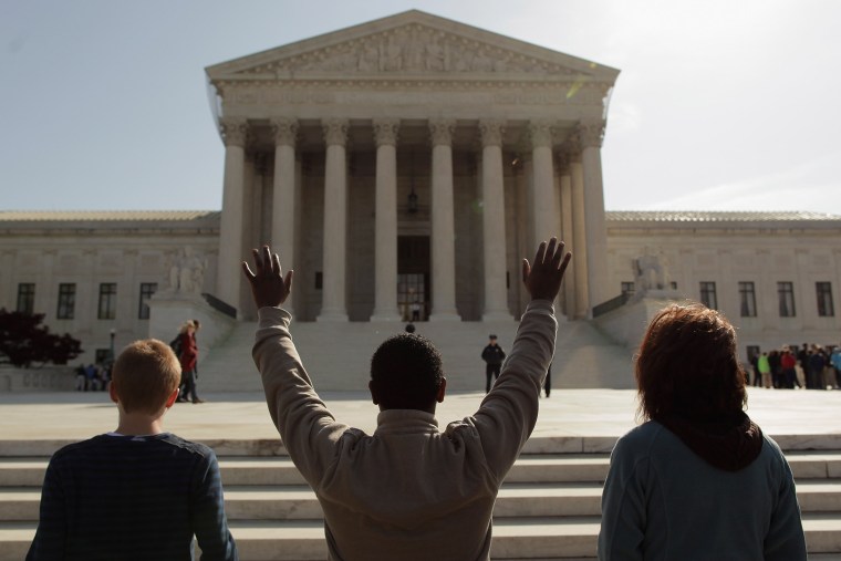 Members of the anti-abortion group Bound4Life pray outside the U.S. Supreme Court on the third day of oral arguements over the constitutionality of the Patient Protection and Affordable Care Act March 28, 2012 in Washington, D.C.