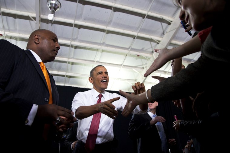 President Barack Obama shakes hands with audience members as he arrives at North Carolina State University to speak about the economy, jobs and manufacturing, Jan. 15, 2014.