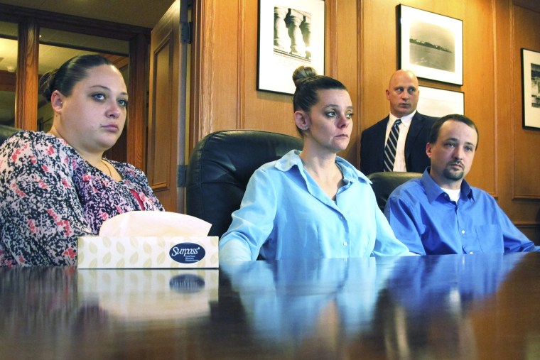 Amber, Dennis, and his wife Missie McGuire, announce their planned lawsuit against the state over the unusually slow execution of their father, Dennis McGuire, Jan. 17, 2014.