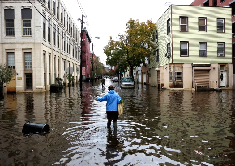 A woman makes her way through the floodwaters, Oct. 31, 2012, in Hoboken, N.J.
