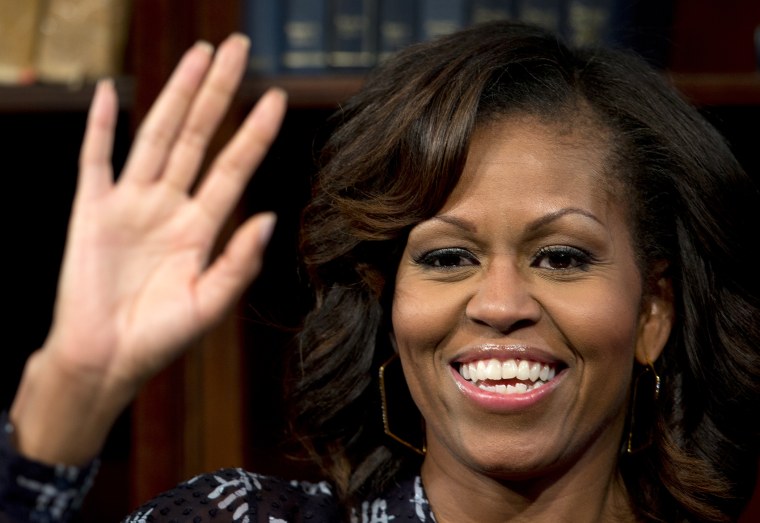 First lady Michelle Obama waves to the audience during an event at, June 29, 2013, in Johannesburg, South Africa.