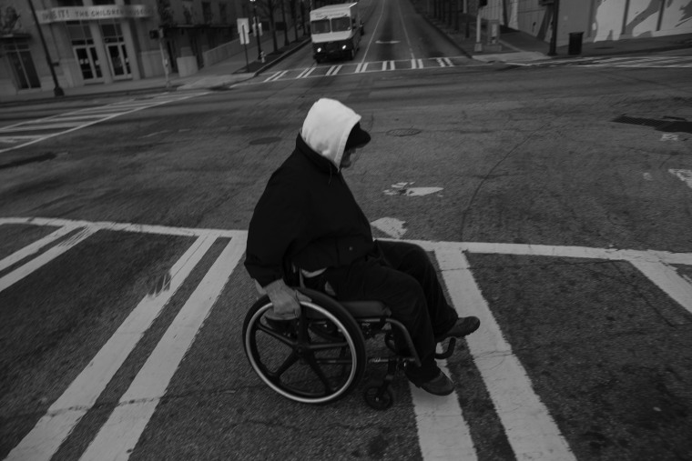 Donn Smith, makes his way up a hill to the CNN Center in Atlanta to get a coffee. 45 and homeless, Donn, born Dong in Vietnam, is the son of an American G.I. and a Vietnamese women. He is wheelchair bound due to Polio. He said that if there are budget cut