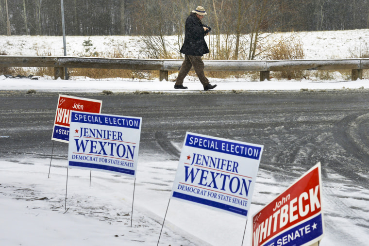 A voter leaves a polling station in Sterling, VA., during the special election for the Virginia 33rd state senate seat, Jan. 21, 2014.