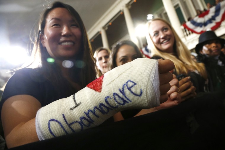 Cathey Park from Cambridge, Mass. shows the words \"I Love Obamacare\" on her cast for her broken wrist Faneuil Hall in Boston on Oct. 30, 2013.