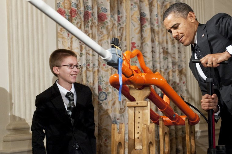 Barack Obama and 14-year-old Joey Hudy use a pump to launch marshmallows during the WHite House Science Fair, Feb. 7, 2012.