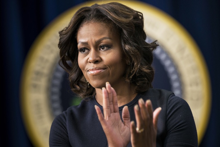 US first lady Michelle Obama applauds during an event at the White House, Jan. 16, 2014.