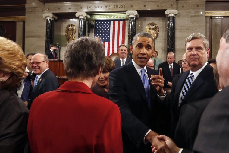 Barack Obama shakes hands after giving the State of Union address, Jan. 28, 2014.