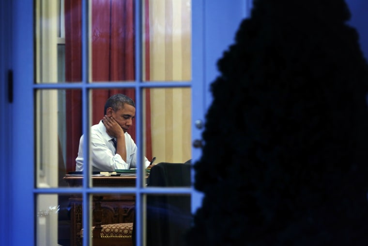 President Obama Works In The Oval Office At The White House