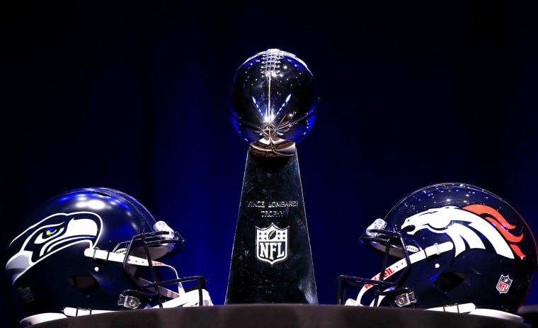 The Vince Lombardi Trophy and helmets for the Denver Broncos and the Seattle Seahawks are displayed prior to a Super Bowl XLVIII, Jan. 31, 2014, in New York, N.Y.