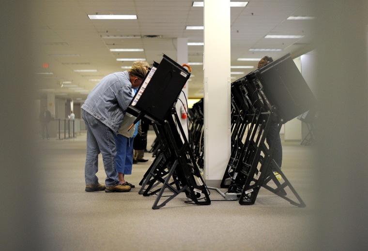 People cast their ballots for the US presidential election at an early voting center, Oct. 15, 2012, in Columbus, Ohio.
