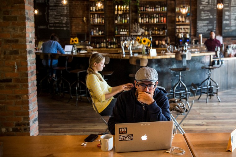 A customer works on his laptop at Great Lakes Coffee Roasting Company in Detroit, Michigan, Sept. 6, 2013.