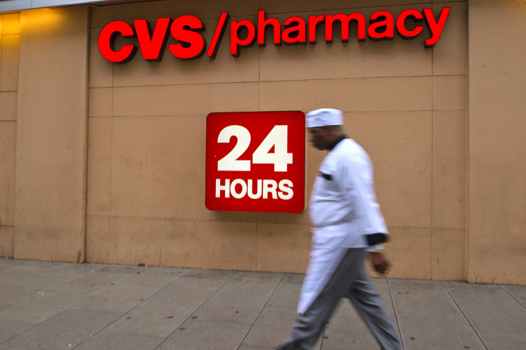 A man passes a CVS drugstore in Washington, DC, Feb. 5, 2014.