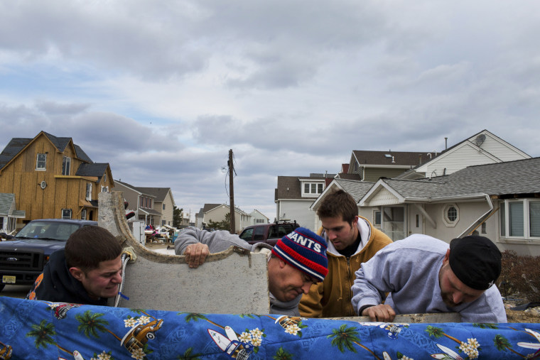 Residents of Ortley Beach, N.J. remove debris after returning for the first time since Hurricane Sandy pulverized the area, Nov. 25, 2012.